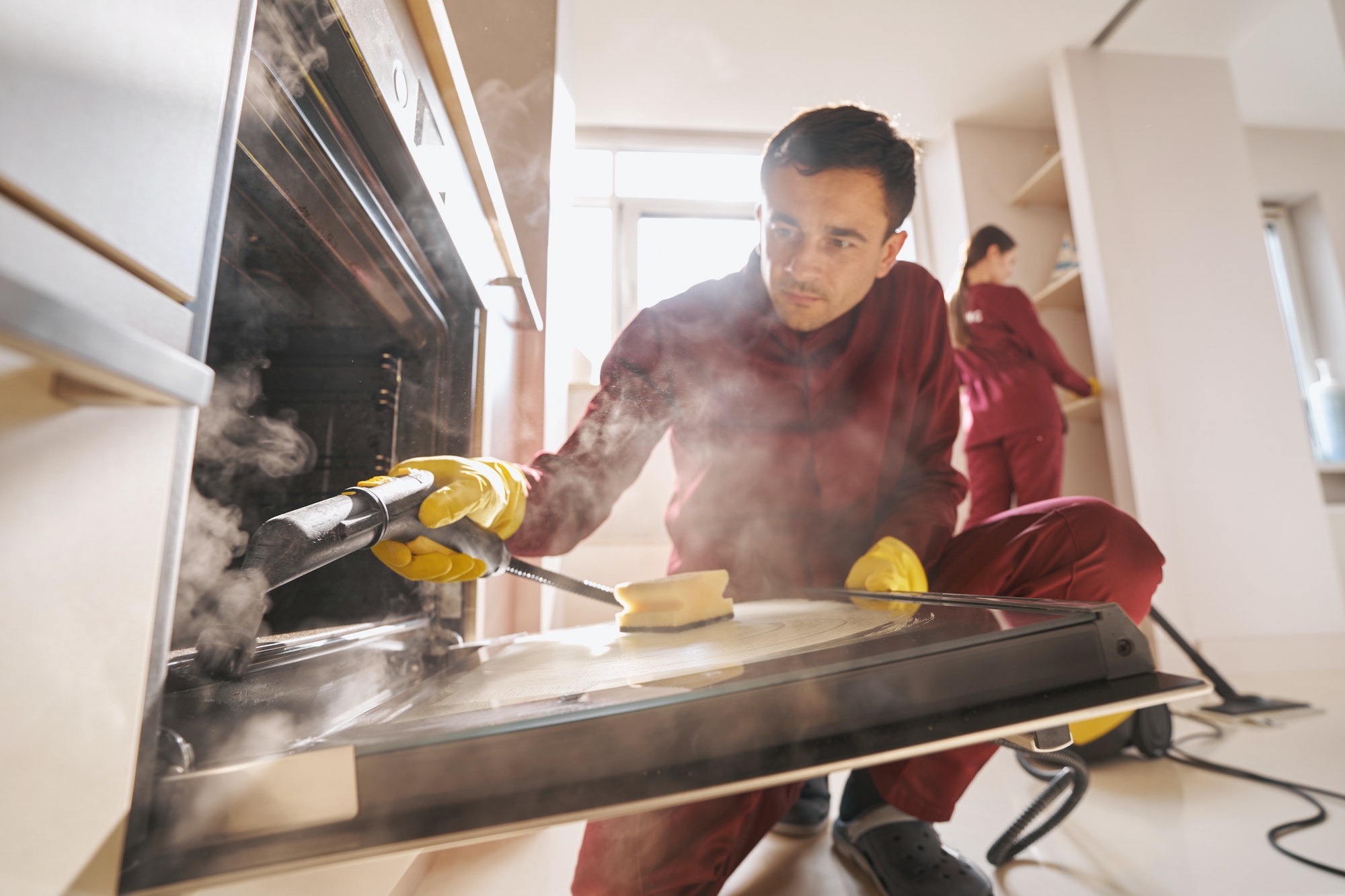 Professional janitorial personnel doing eco-friendly kitchen cleaning Oven cleaners